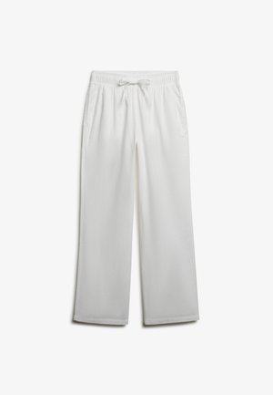 Pantalon blanc à jambes larges avec ceinture élastique et cordon, doté de poches latérales, présenté sur un fond uni.