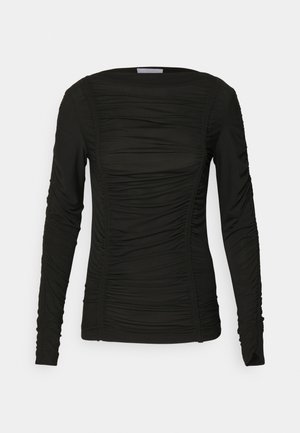Zwarte top met lange mouwen gemaakt van zacht materiaal, met plooidetails langs de voorkant en de mouwen, en voorzien van een ronde halslijn en een aansluitend ontwerp.