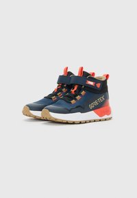 Blue and orange high-top Gore-Tex sneakers with tan soles, velcro straps, and pull tabs, shown side by side on a white background.