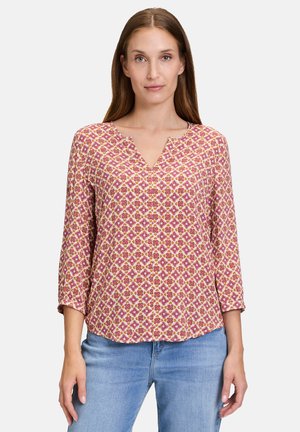 Floral-patterned blouse with a V-neck, three-quarter sleeves, in pink, yellow, and white. Made from lightweight fabric, features a relaxed fit.