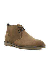 Brown suede ankle boot with round toe, black laces, and a thin rubber sole. Features a pull tab on the back for easy wear.