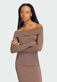 Brown off-the-shoulder long-sleeve top made of a smooth fabric with a fitted design. Features a subtle logo on the chest and seamless texture.