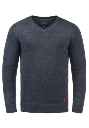 Dark gray knitted sweater, v-neck design, long sleeves, ribbed cuffs and hem, with a small leather logo patch at the bottom left.