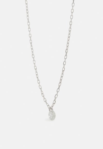 Silver chain necklace with oval textured pendant. Links are elongated and evenly spaced. Pendant has a small, clear, faceted stone.