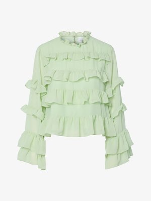 Šviesiai žalia palaidinė, turinti kelis sluoksnius ruffles ant kūno ir rankovių. Minkšta medžiaga su aukštu volanu ir ilgomis, plačiomis rankovėmis.