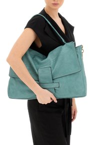 Borsa a spalla in pelle teal con chiusura a pattina, cuciture verticali e tracolla regolabile. Presenta una grande tasca anteriore con chiusura a scatto.