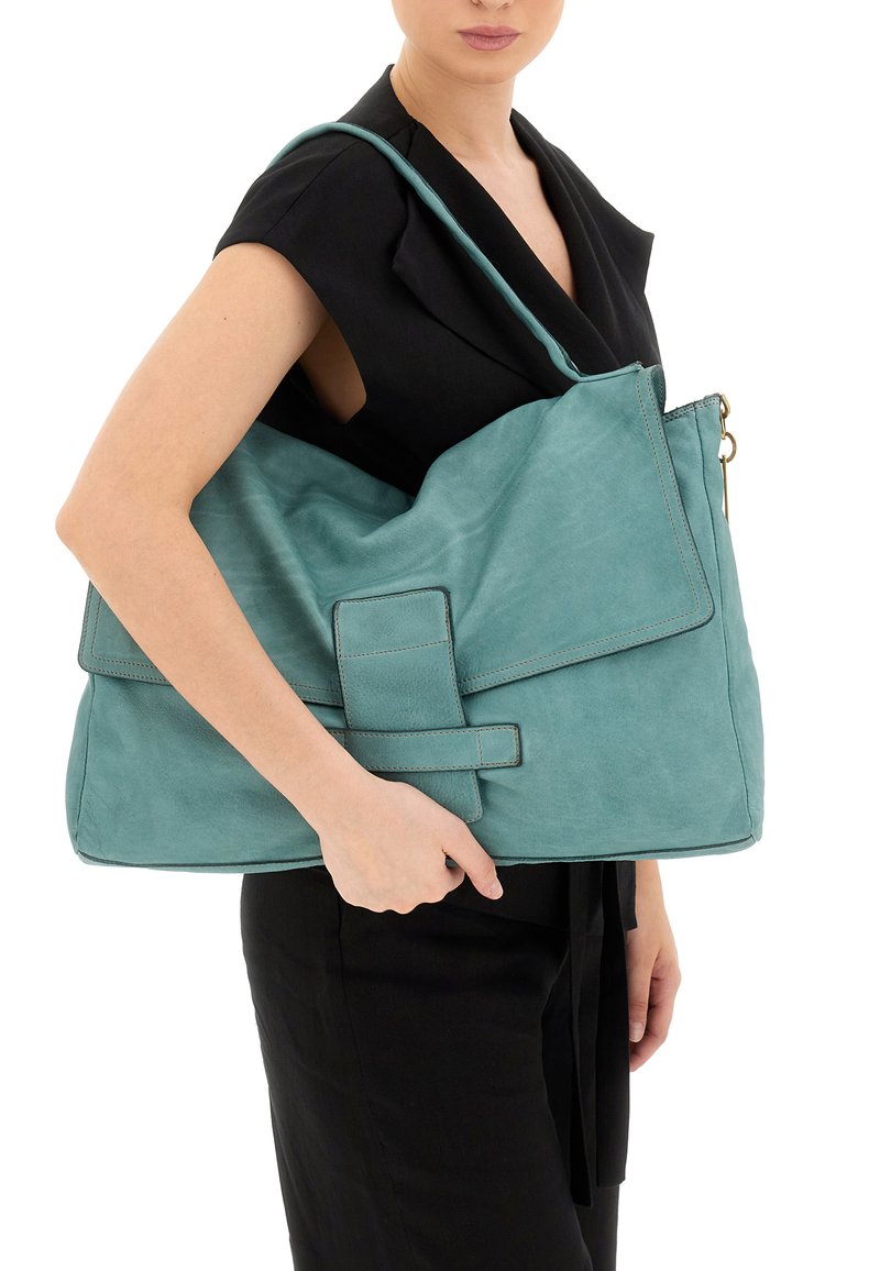 Borsa a spalla in pelle teal con chiusura a pattina, cuciture verticali e tracolla regolabile. Presenta una grande tasca anteriore con chiusura a scatto.