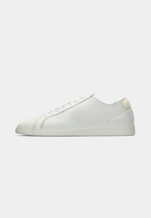 Low-top white leather sneaker with flat sole, lace-up front, and subtle embossed "cK" logo on side.