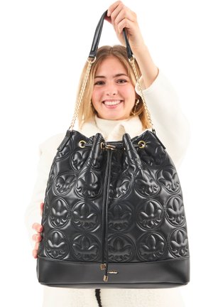 Black bucket bag made of quilted leather, featuring a floral pattern, gold chain accents, and drawstring closure. Smooth texture, spacious design.