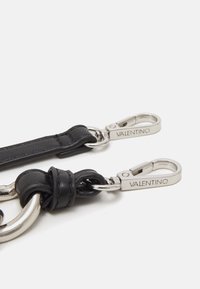 Black leather strap with silver-tone metal hardware. Features a knotted section and two snap hooks engraved with "Valentino."