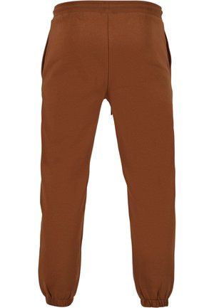 Rudos džinsai pagaminti iš minkštos medžiagos, su elastinga juosmens juosta, šoninėmis kišenėmis ir elastinėmis juostomis ties kulkšnimis.