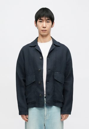 Navy blue jacket made of textured fabric, featuring a button-up front, two large front pockets, and a classic collar design.