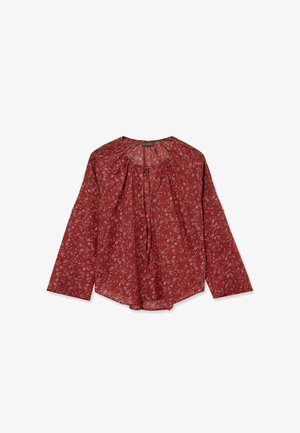 Red long-sleeve blouse with white floral pattern, round neckline, gathered fabric details, and loose fit.