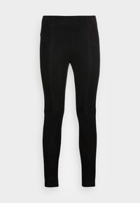 Svarta leggings av mjukt tyg med en len yta. Har platta sömmar och en åtsittande design som sträcker sig till ankellängd.