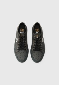 Black sneakers with star pattern, black laces, gold eyelets, logo detail on the side, rubber sole, and padded collar for comfort.