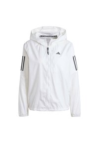 Valkoinen kevyt takki hupulla, jossa mustat kolmen raidan koristeet hihoissa ja vetoketjusuljenta edessä.