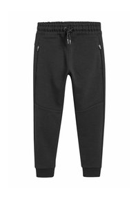 Schwarze Jogginghose aus einem weichen Stoff. Sie hat einen elastischen Bund mit Kordelzug, seitliche Reißverschlusstaschen und schmal zulaufende Bündchen.