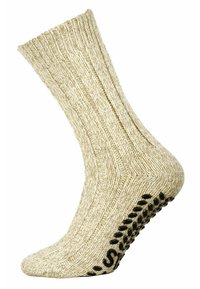 Calzino in cotone beige con texture a coste, dotato di suola imbottita e punti neri antiscivolo per una migliore aderenza.