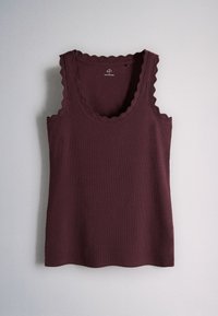 Dark burgundy sleeveless ribbed tank top with scalloped edges on neckline and armholes, laid flat on a light surface.