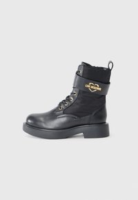 Black lace-up boots in a combination of smooth leather and nylon, featuring a gold "LOVE MOSCHINO" logo and a chunky black sole.