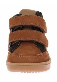 Zapatilla de gamuza marrón con dos correas de velcro ajustables, acentos negros, suela de goma resistente y diseño de punta redonda.