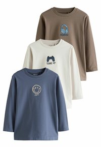 Trois t-shirts à manches longues : marron avec des écouteurs, blanc avec une manette de jeu, bleu avec un smiley. Tous présentent des graphiques brodés.