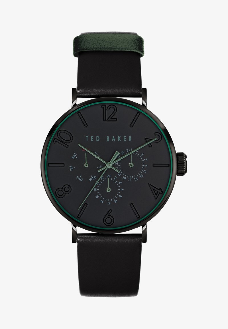 Mustaga analoogkell roheliste aktsentidega, must nägu, suured tunni markeerijad ja alamdialid päeva ja kuupäeva jaoks. Must nahast rihm.