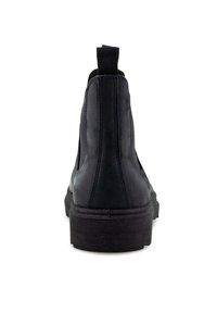Bottines Chelsea en cuir noir avec des panneaux élastiques sur les côtés, une finition lisse et une semelle en caoutchouc robuste, dotées d'une languette à l'arrière.