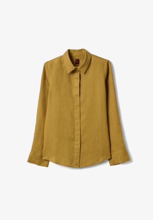 Chemise jaune moutarde à manches longues avec col classique et boutons dissimulés, présentée à plat sur un fond blanc.