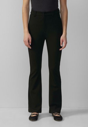 Black flared pants with a smooth texture, featuring a zip and button closure, side pockets, and a fitted waist.