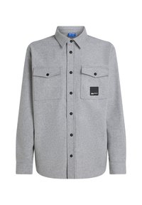 Camisa de franela gris de manga larga, con botones en la parte delantera, dos bolsillos en el pecho y un parche de logo negro. Presenta botones negros y un cuello clásico.