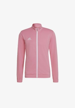 Giacca sportiva rosa con zip realizzata in tessuto leggero. Caratterizzata da un colletto alto, maniche lunghe e logo adidas bianco sul lato sinistro del petto.