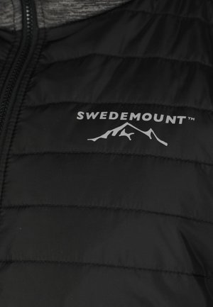 Black puffer jacket featuring quilted sections, a zip closure, and a white logo with mountain design on the left side. Soft texture.