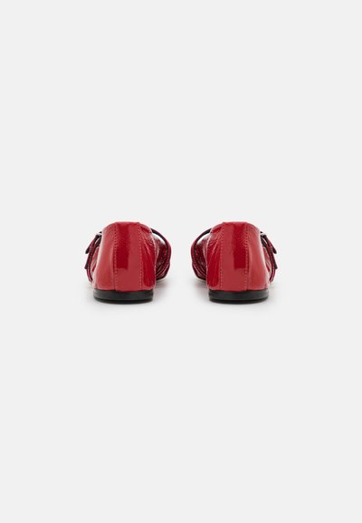 Red patent leather loafers with a smooth texture, rounded toe, and small black soles. Decorative bow accents on the front sides.