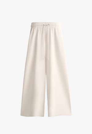 Pantaloni corti a gamba larga color crema realizzati in tessuto leggero, dotati di una vita elastica con coulisse per una vestibilità regolabile.