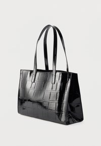 Black patent leather tote bag with a textured, quilted design, featuring two long handles and a structured rectangular shape.