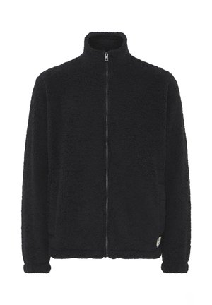 Chaqueta de forro polar negra con cuello alto, cierre frontal completo y superficie texturizada. Presenta bolsillos laterales y un pequeño acento de etiqueta.