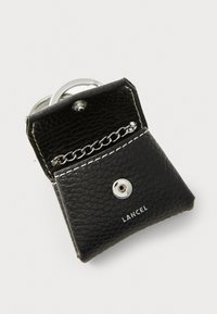 Black leather keyring holder with a textured finish, silver hardware, snap closure, chain accent, and embossed "LANCEL" branding.