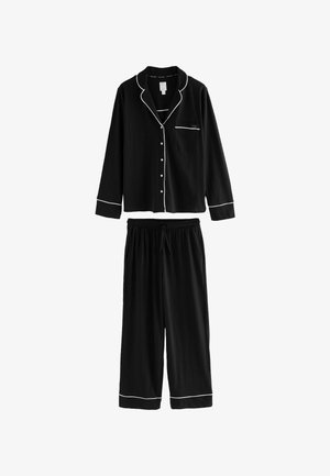 Black pajama set featuring a long-sleeve button-up top with a chest pocket and white piping, paired with elastic-waist, wide-leg pants.