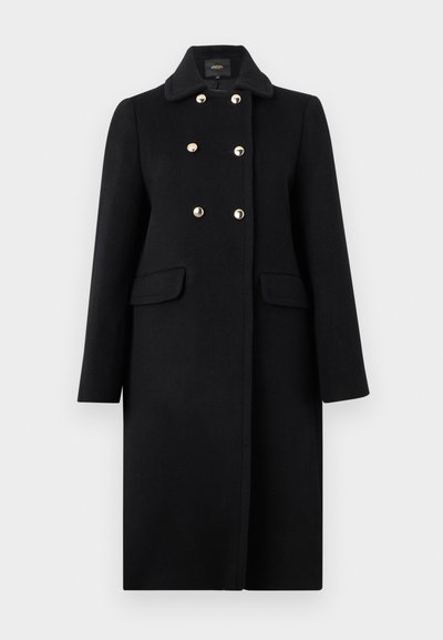 Schwarzer langer Wollmantel mit weitem Kragen, sechs metallischen Knöpfen im doppelreihigen Stil und zwei Fronttaschen mit Klappe.