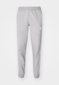 Grå sweatpants i en bomullsblandning med en tapered passform, elastisk midja och vita sidremsor. Logotyp på vänster lår.