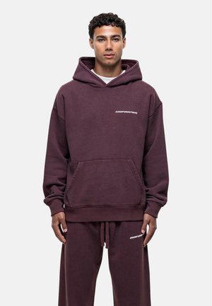 Burgundy hoodie with a front pocket, drawstring hood, and white text "GOODFORNOTHING" on the chest, made from soft, textured fabric.