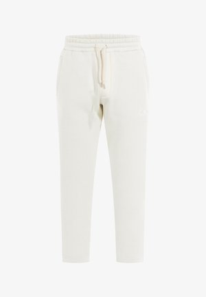 Jogger crema chiaro realizzati in tessuto morbido, caratterizzati da un elastico in vita, coulisse e tasche laterali. Dettaglio logo discreto sulla gamba.