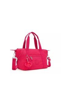 Pink fabric handbag with dual handles and detachable shoulder strap. Features a front zip pocket and a monkey-shaped charm.