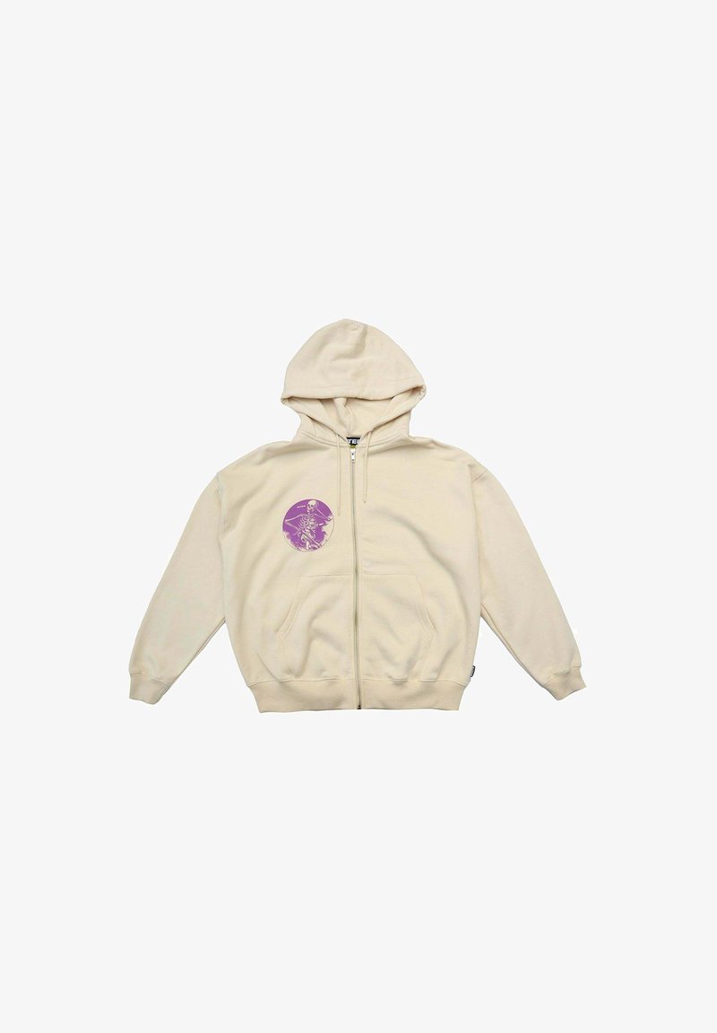Felpa beige con zip e texture morbida. Presenta una grafica rotonda viola sul lato sinistro del petto, tasche laterali e polsini a coste.