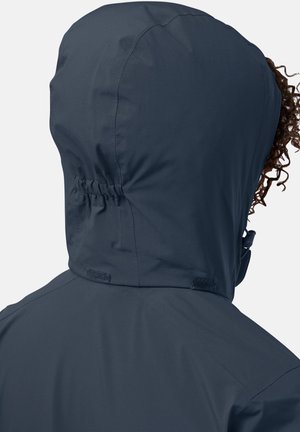 Veste à capuche bleu foncé avec un col resserré, texture lisse et coutures plates. Présente des fermetures velcro à l'arrière du cou.