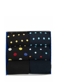Set aus sechs Paar gestrickten Socken in dunklen Farbtönen, mit verschiedenfarbigen Punktemustern. Verpackt in einer Box mit blauen und gelben Designelementen.