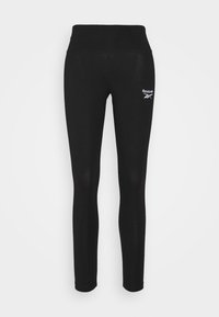 Svarta leggings med hög midja, tillverkade av stretchigt material. Har en liten vit Reebok-logotyp på övre vänstra sidan.