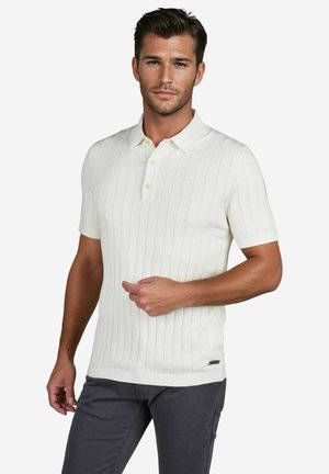 Ivory short-sleeve polo with vertical ribbed texture and three-button placket, featuring a subtle logo accent at the hem.