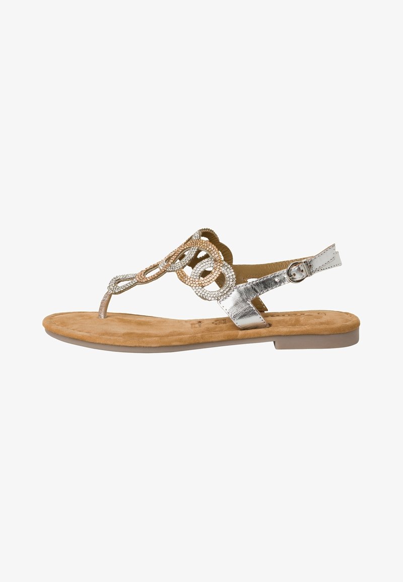 Silver metallic thong sandals with a flat sole, featuring a decorative beaded design and an adjustable ankle strap. Suede-like footbed.
